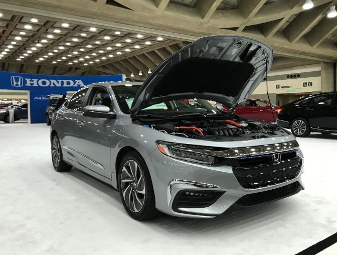 Honda Insight, with hood up, in silver.