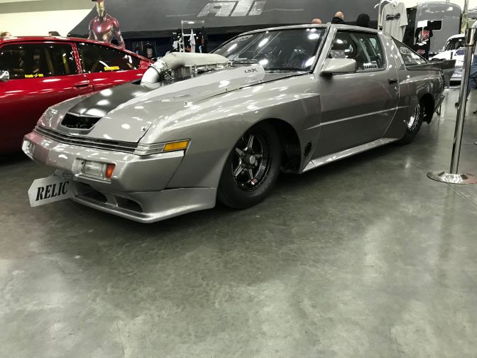 Silver Chrysler Conquest drag race car.