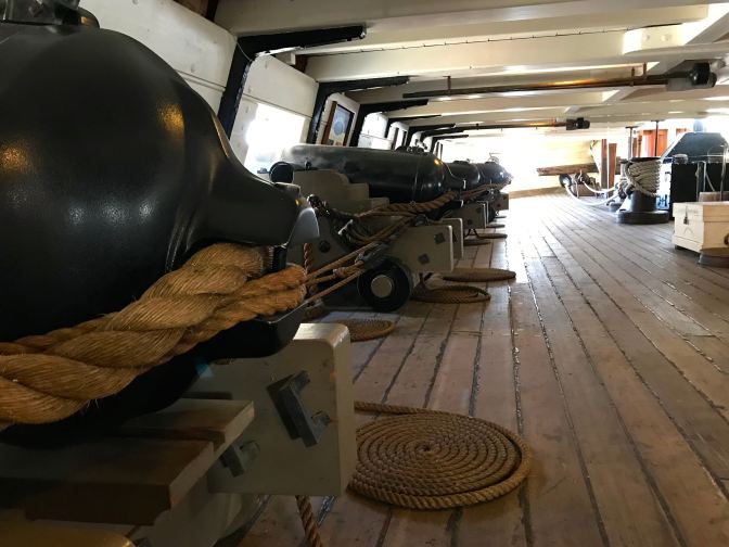 Gun deck, with four cannons pictured.