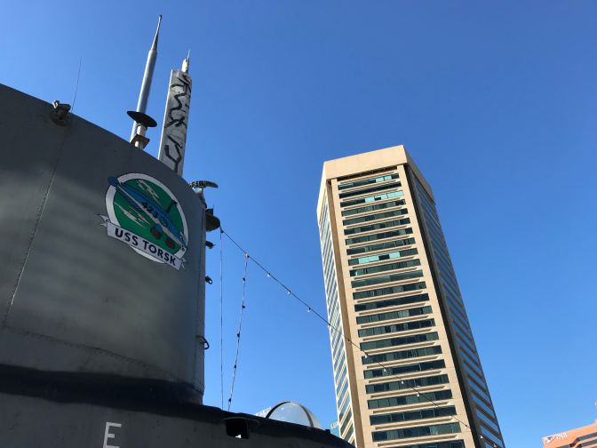 Sail of USS Torsk, with the Baltimore World Trade Center in the background.