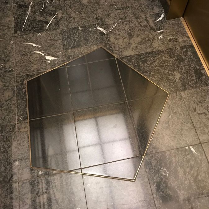 Pentagon-shaped design in elevator floor.