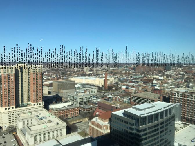Looking north at skyline, names are inscribed on the window.