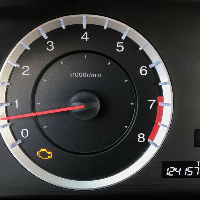 Gauge cluster of Honda Accord with check engine light illuminated.