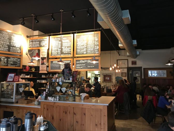 Interior of Jammin Crepes. A large series of chalkboards hang over the counter with the menu.