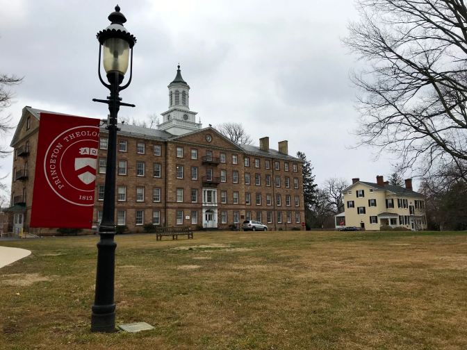 Academic building, with a lamppost in foreground. A sign says PRINCETON THEOLGOICAL