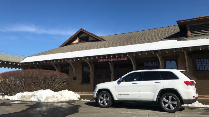 White Jeep Grand Cherokee in front of Danbury Railway Museum.