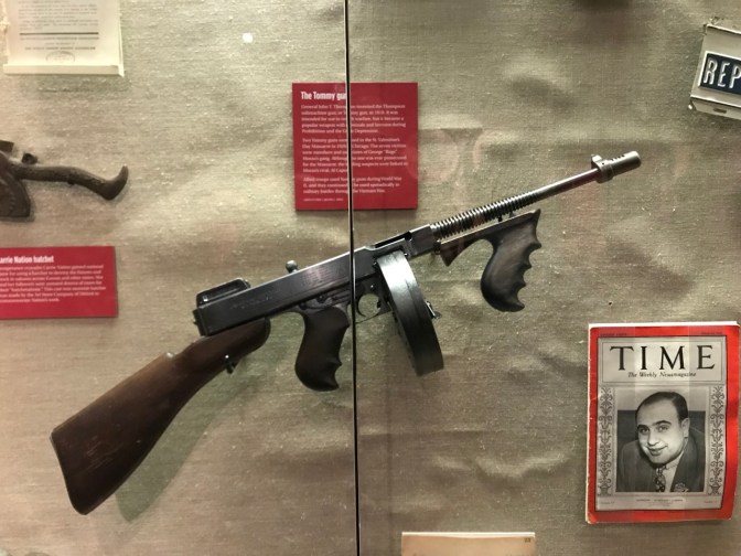 Tommy Gun, mounted on wall in display case.