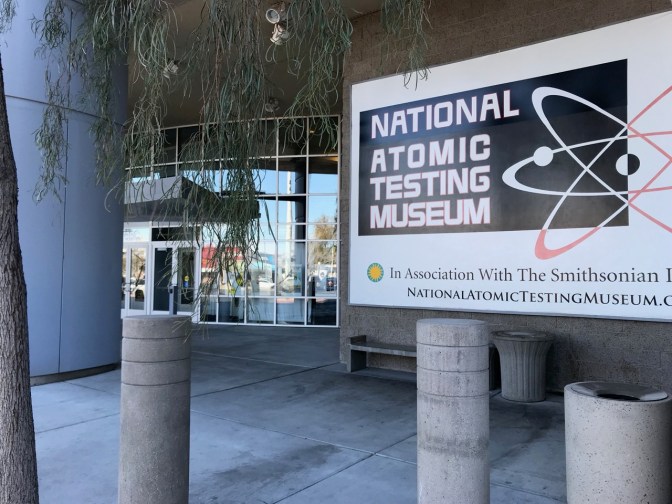 Entrance to National Atomic Testing Museum, with a large sign with the museum's name by the entrance.