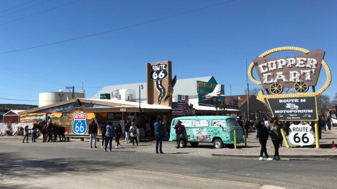 Copper Cart tourist shop in Seligman, Arizona. Tourists amble about outside.