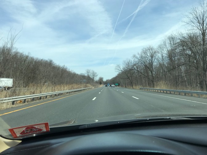 View of highway from behind dashboard of Honda Accord.
