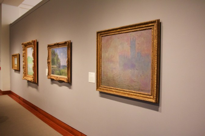 Gallery with four impressionist paintings on the wall.