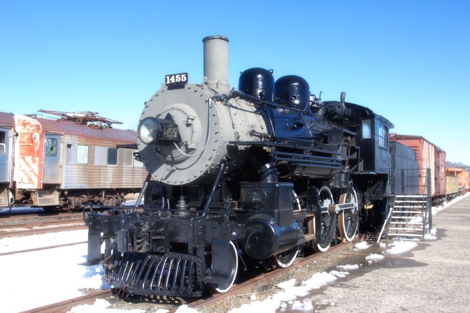 Steam locomotive, in black with a grey nose. The number 1455 is on the nose.