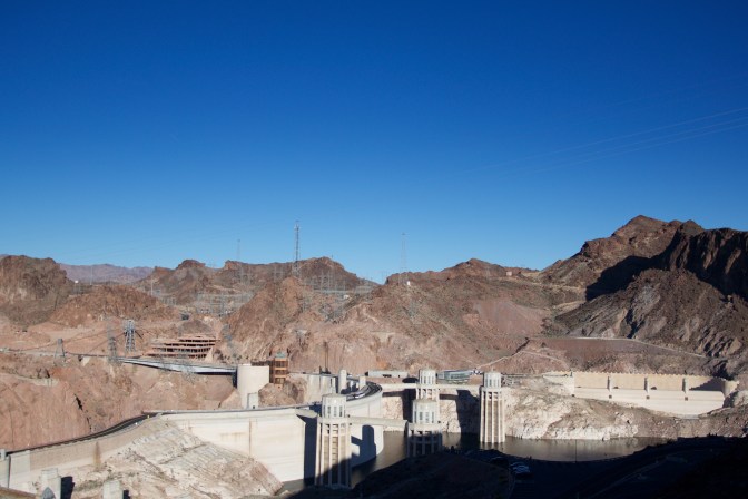 View of Hoover Dam and rocky landscape near it.