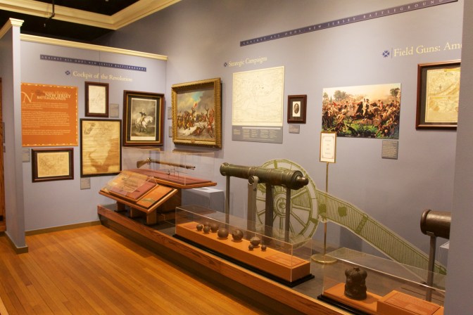 Interior of museum, with an exhibit on cannons and rifles from the Revolutionary War.