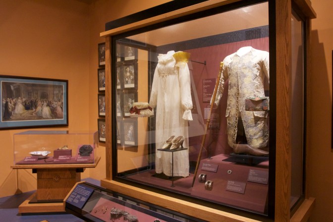 Glass case with dress attire of George and Martha Washington.
