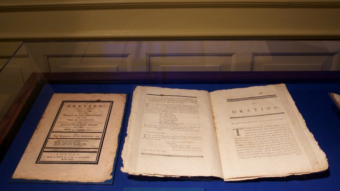 Oration pamphlet of John Hancock on a purple backdrop.