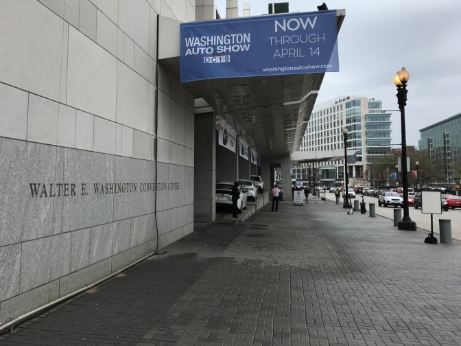 Exterior of Walter E. Washington Convention Center, with a sign saying WASHINGTON AUTO SHOW DC 19 NOW THROUGH APRIL 14