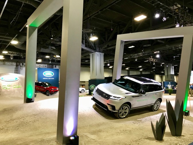 Land Rovers on a fake obstacle course.