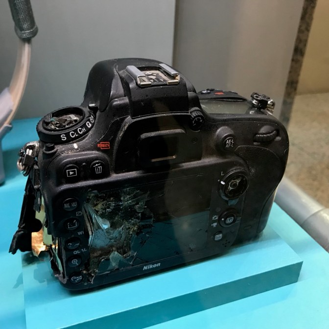Camera, damaged in the back.