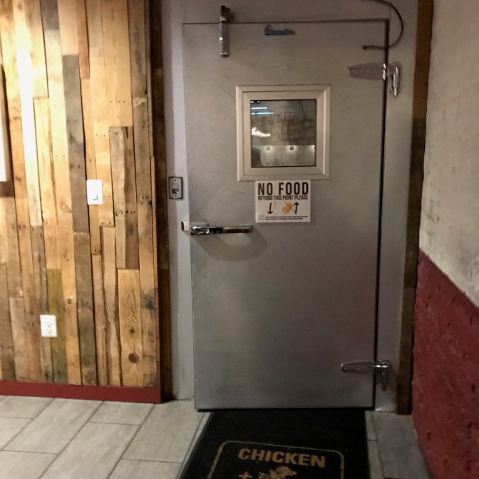 Freezer door that says NO FOOD BEYOND THIS POINT PLEASE.