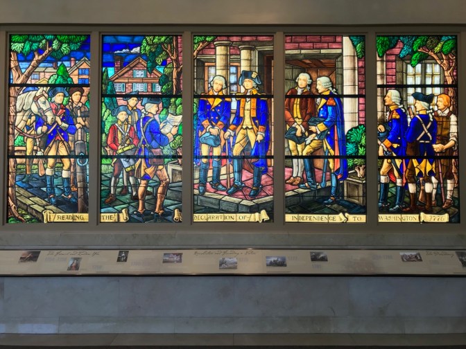 Stained glass window with the story of the reading of the Declaration of Independence to Washington.