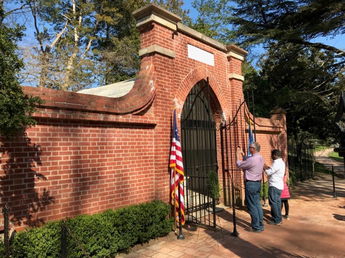 Washington's Tomb, in brick, with iron gates opened in front of it.