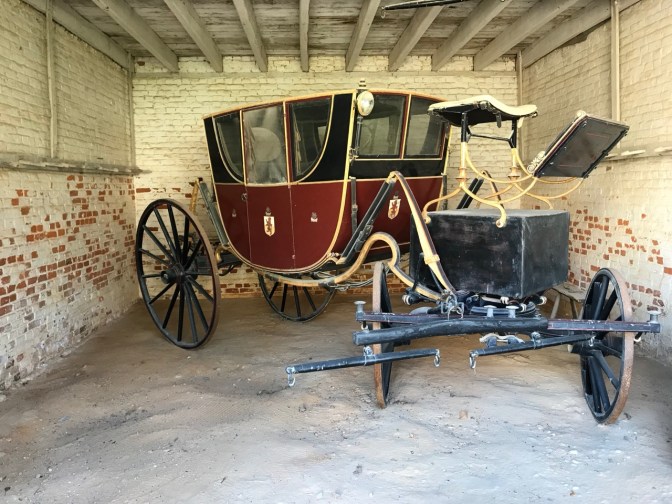 Red coach in carriage house.