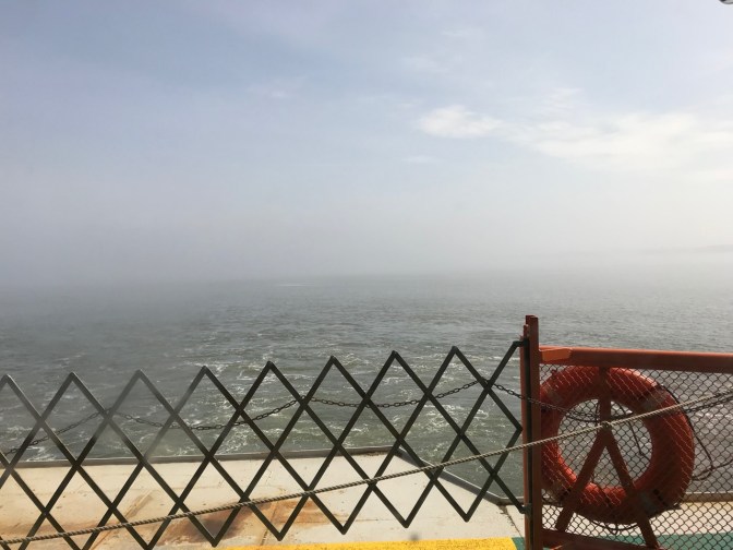 Bow of ferry, with fog in the distance.