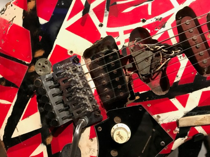 Closeup shot of tremolo, pickups, and volume knob of Frankenstein guitar.