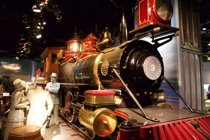 Steam locomotive, with mannequin passengers in the foreground.