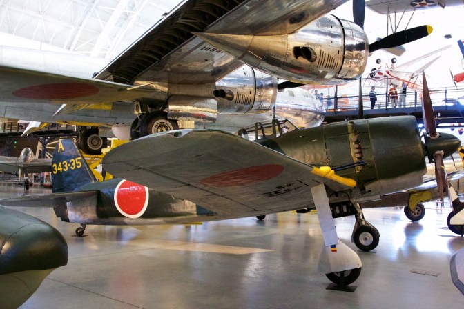 Kawanishi N1K2-J Shiden Kai fighter jet, with rising sun emblem on wings and fuselage.