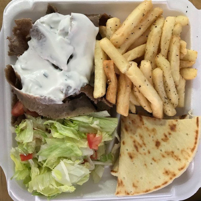 Gyro platter with lamb meat, lettuce, pita, and french fries.