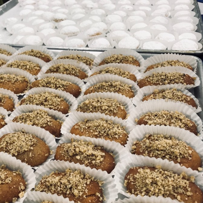 Greek pastries in rows on baking sheets.