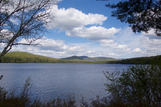 View of Sagamore Lake with mountains in the background.