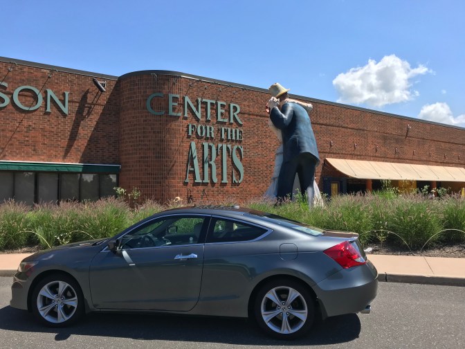 2012 Honda Accord in front of welcome center. A large statue of a couple dancing is in the background.