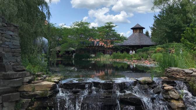 Exterior of Rat restaurant with a waterfall in the foreground.