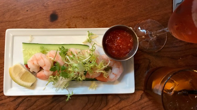 Platter with shrimp cocktail, and a glass of cava and an Old Fashioned.