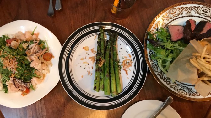 Seafood salad, grilled asparagus, and steak frites.