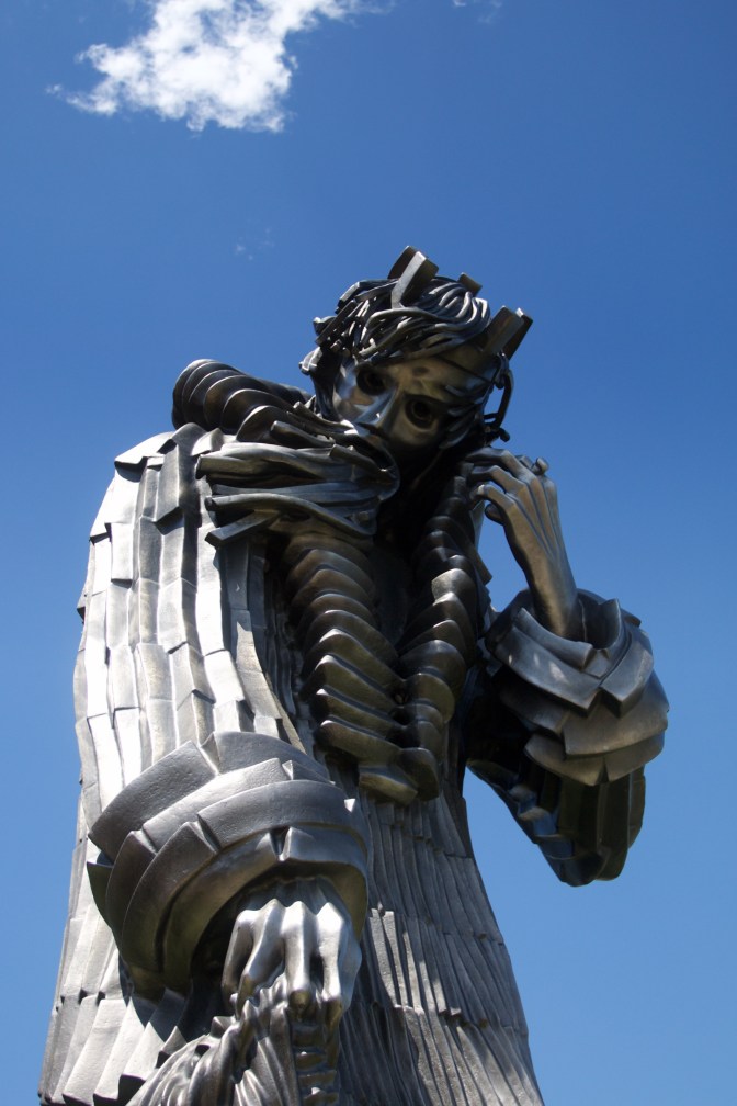 Large bronze statue of man.