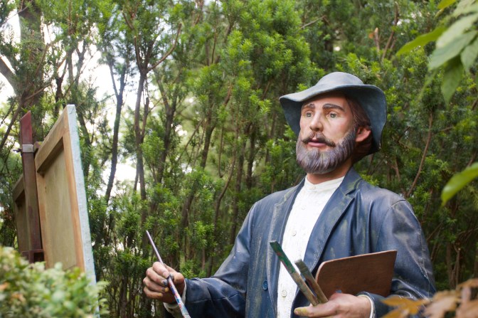 Sculpture of artist painting at easel.