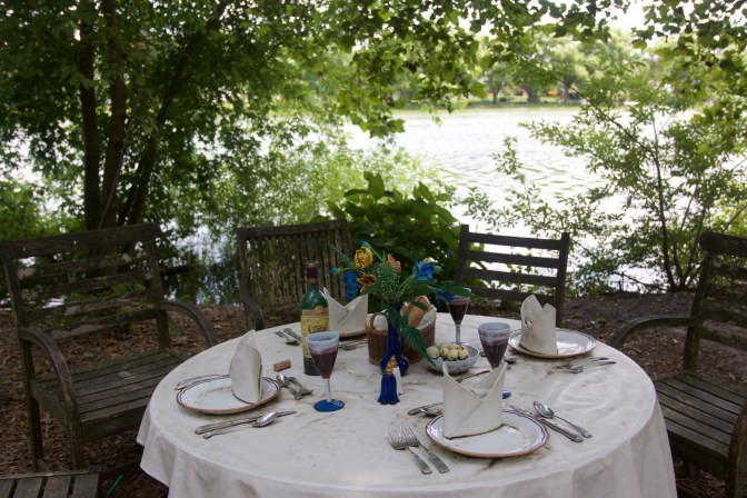 Table set for dinner, with four chairs around it.