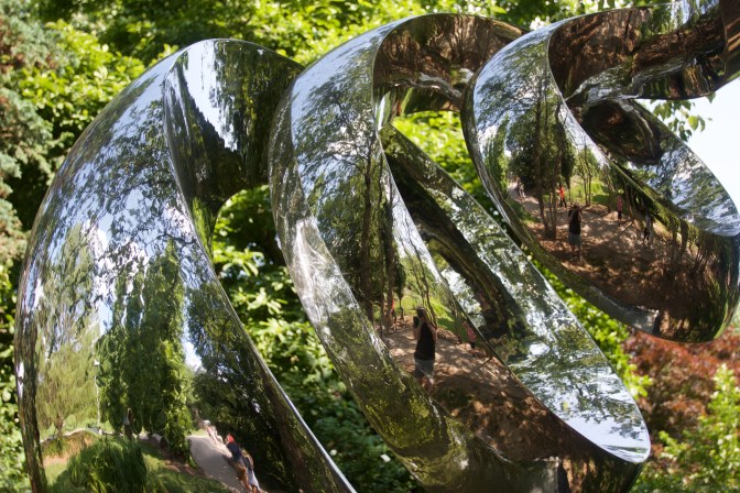 Spiral sculpture, with a reflection of the background.