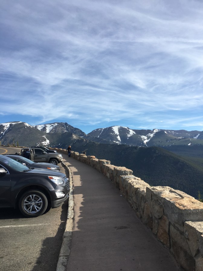 View of cars parked in stone-walled pullout.