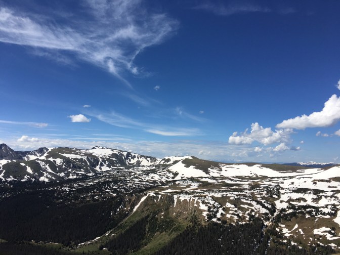 Snow-covered mountains beneath a blue sky.
