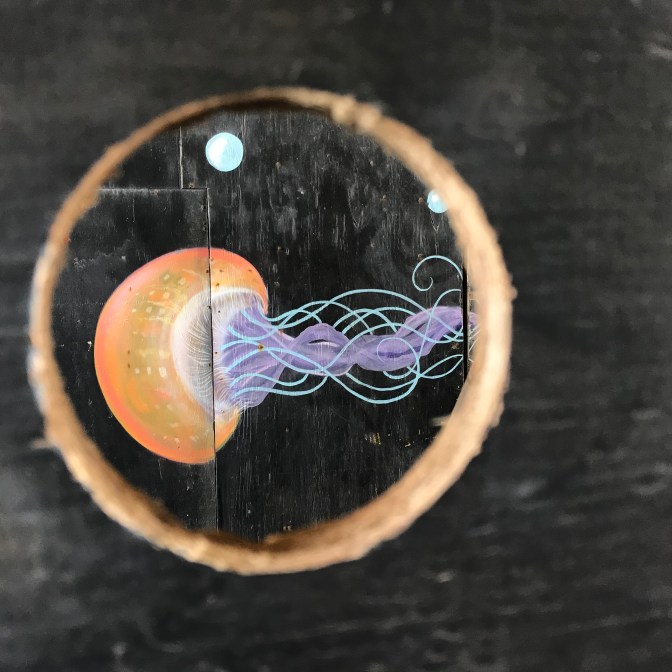 Mural of octopus through hole in wall.