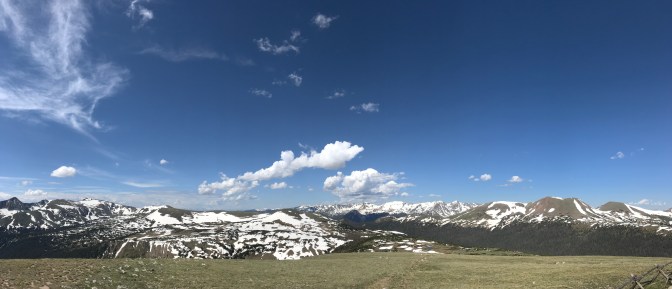 Panorama of mountains, with a blue sky.