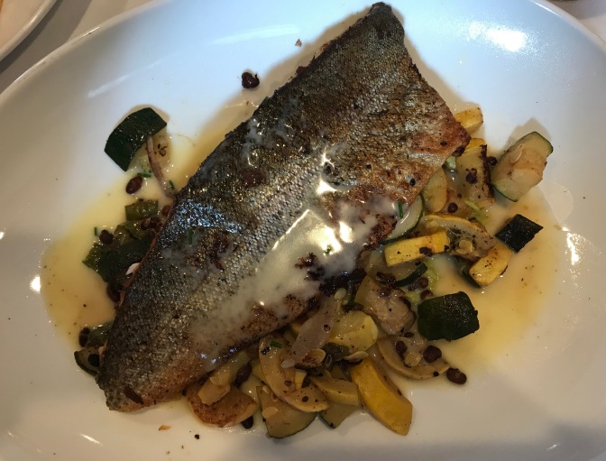 Trout and vegetables on white plate.