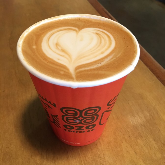Latte with heart-shaped milk design on top.