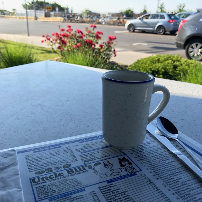 Coffee cup and menu for Uncle Bill's with Ocean Drive in Cape May in the background.