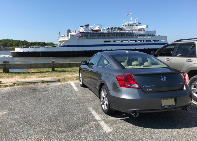 Gray Honda Accord coupe parked, with Cape May Ferry in distance.